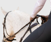 Person riding a horse with the brown Correct Connect Double Neck Strap.